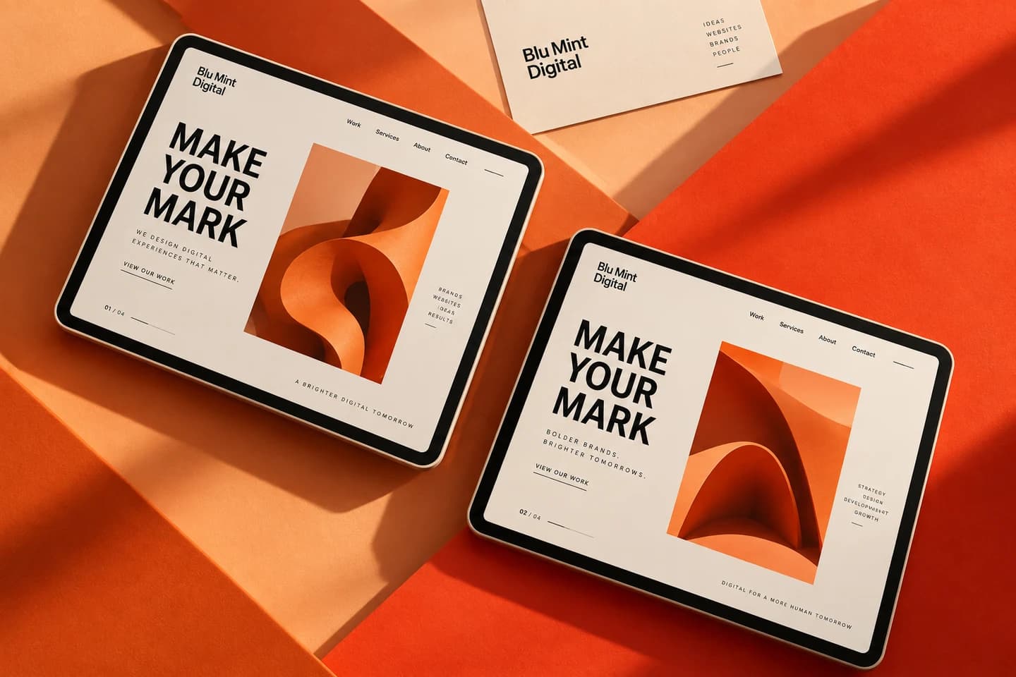 Blu Mint Digital website concepts on two tablets, arranged across orange and apricot surfaces