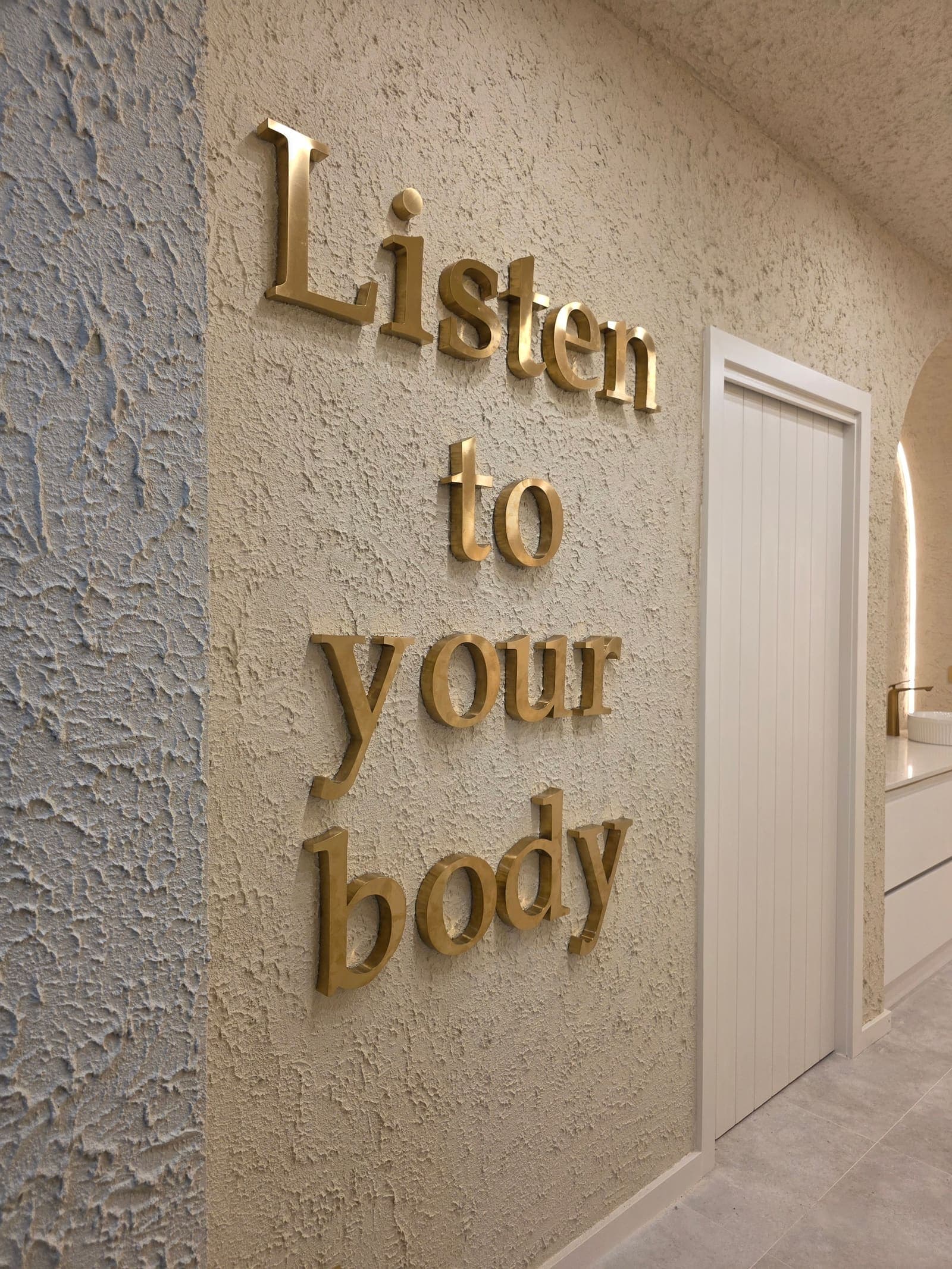 Gold 'Listen to your body' lettering at Paradise Skin Clinic